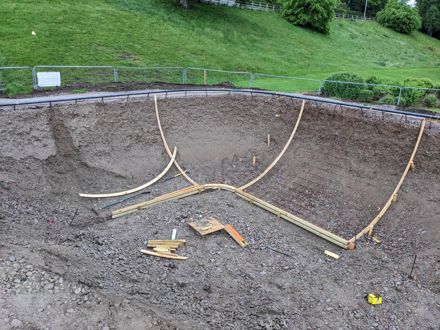 Timber formwork and rebar shaping the bowl during construction