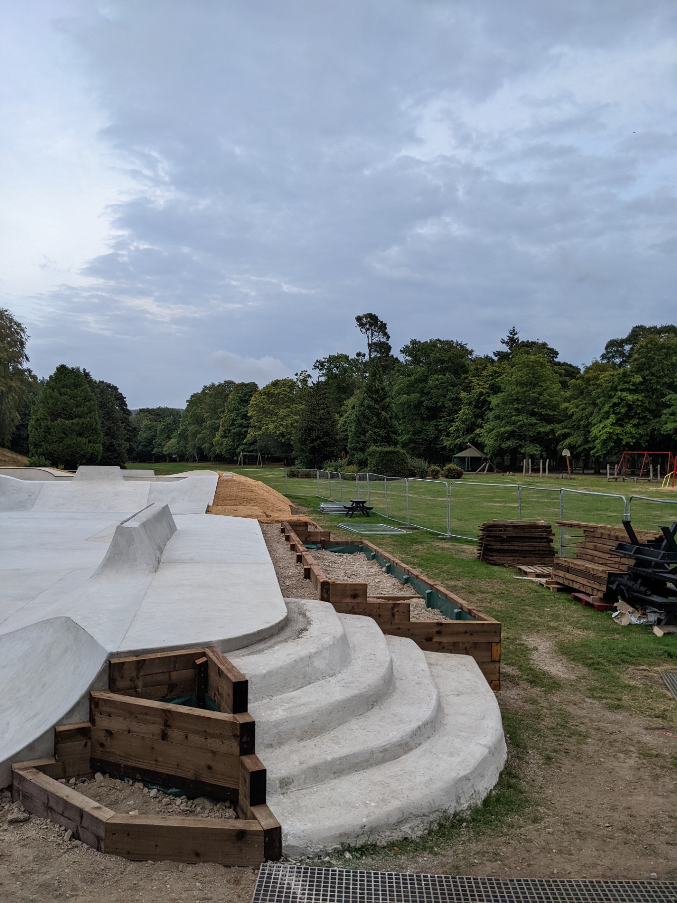 Curved concrete steps and viewing area looking out across Bellfield Park