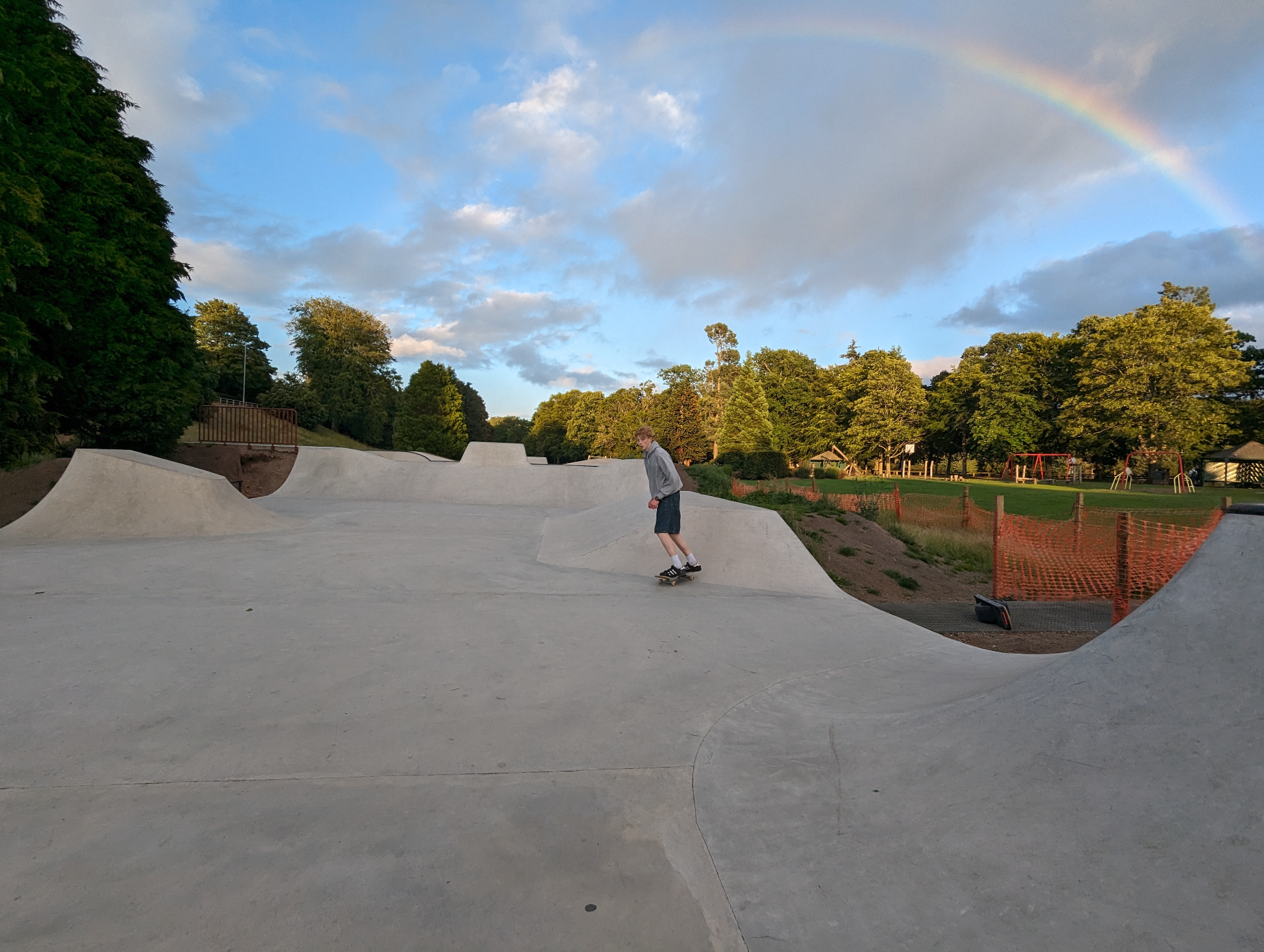 Skater carving Banchory Skatepark under a rainbow