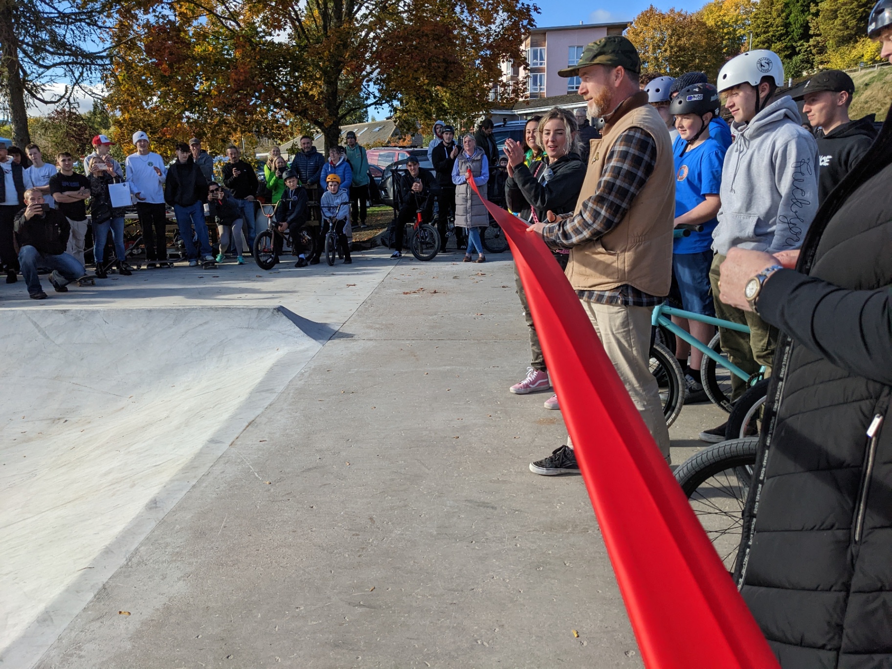 Wider view of the finished skatepark with riders rolling between features