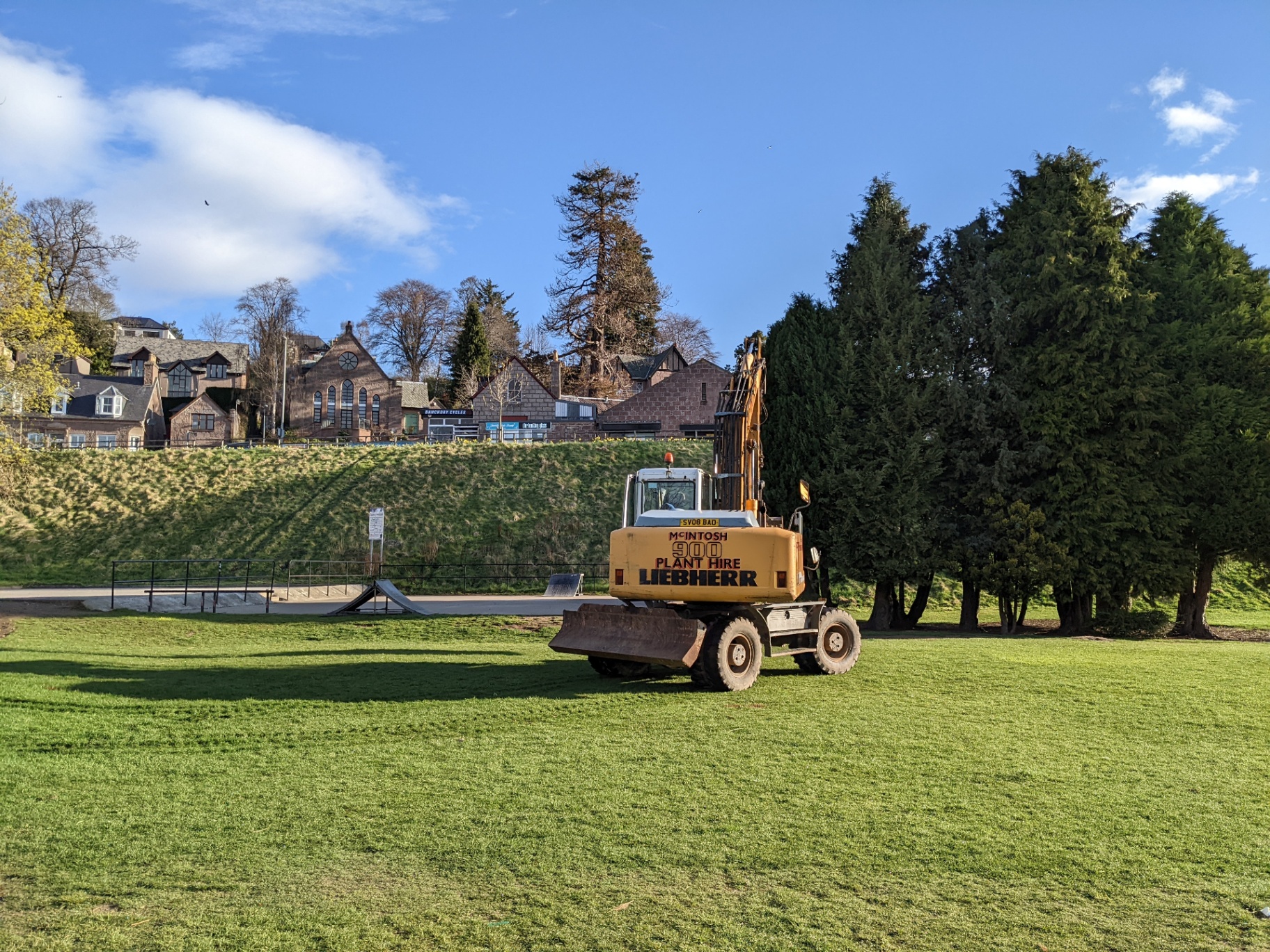 The site in April 2022 with the excavator on the green, Banchory rooftops in the background